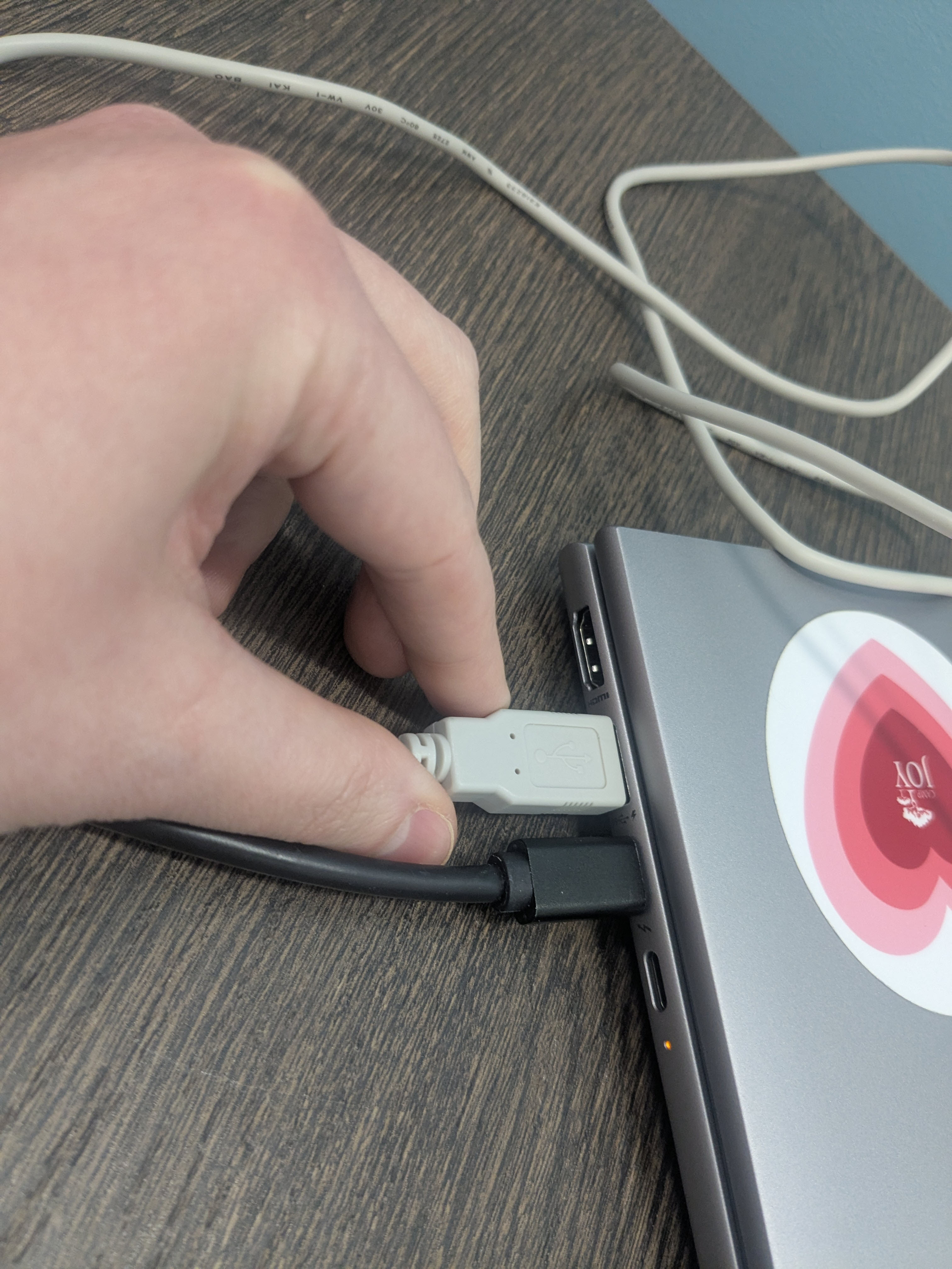 Image of NFC reader being plugged into a USB port on a computer